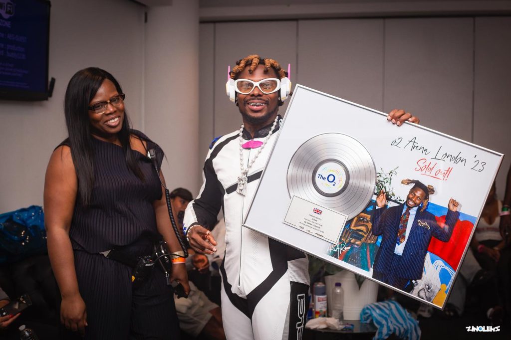 Asake with his O2 Arena sold out plaque